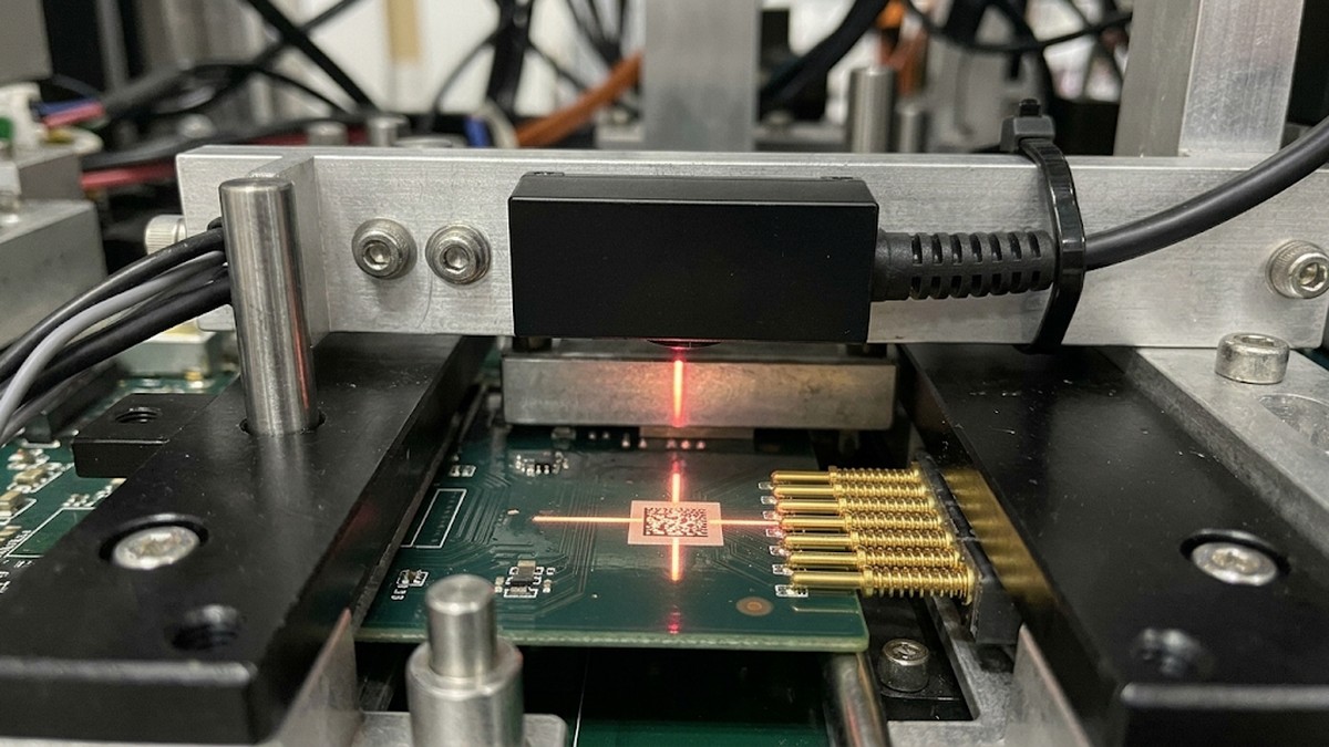 G4503 16.8mm ultra-thin fixed-mount DPM barcode scanner with downward window reading laser-engraved Data Matrix code inside a PCBA ICT test fixture